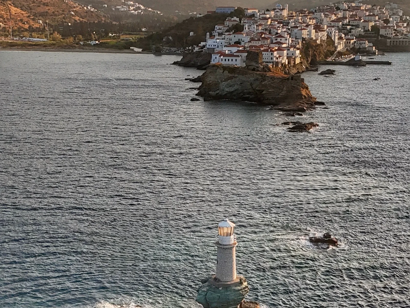 The Tourlitis lighthouse on its rock before Chora, the capital of Andros