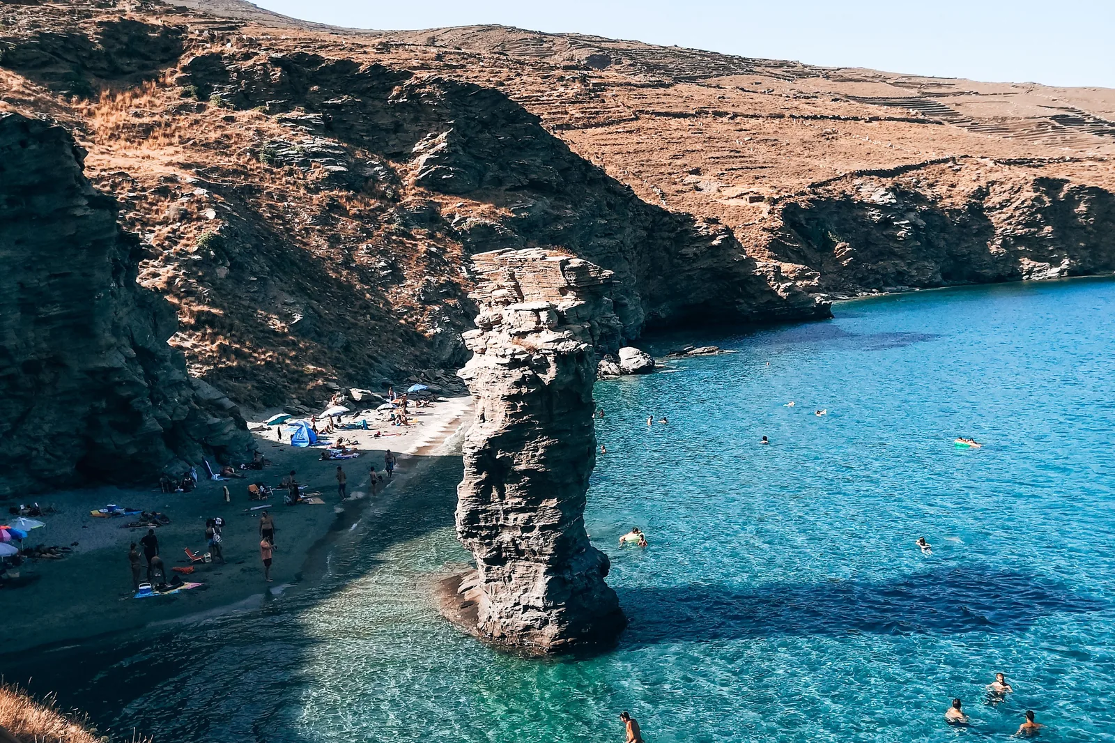 Swimmers around the sea stack at Tis Grias to Pidima beach on Andros