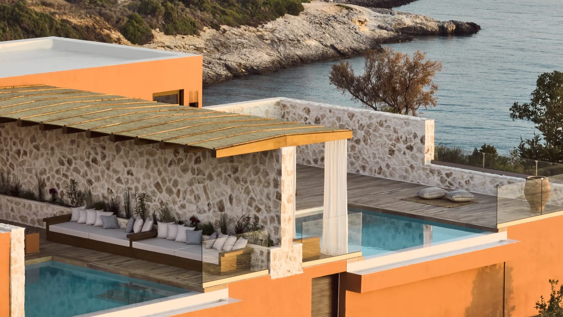 A villa terrace with plunge pools above a turquoise cove on Zakynthos