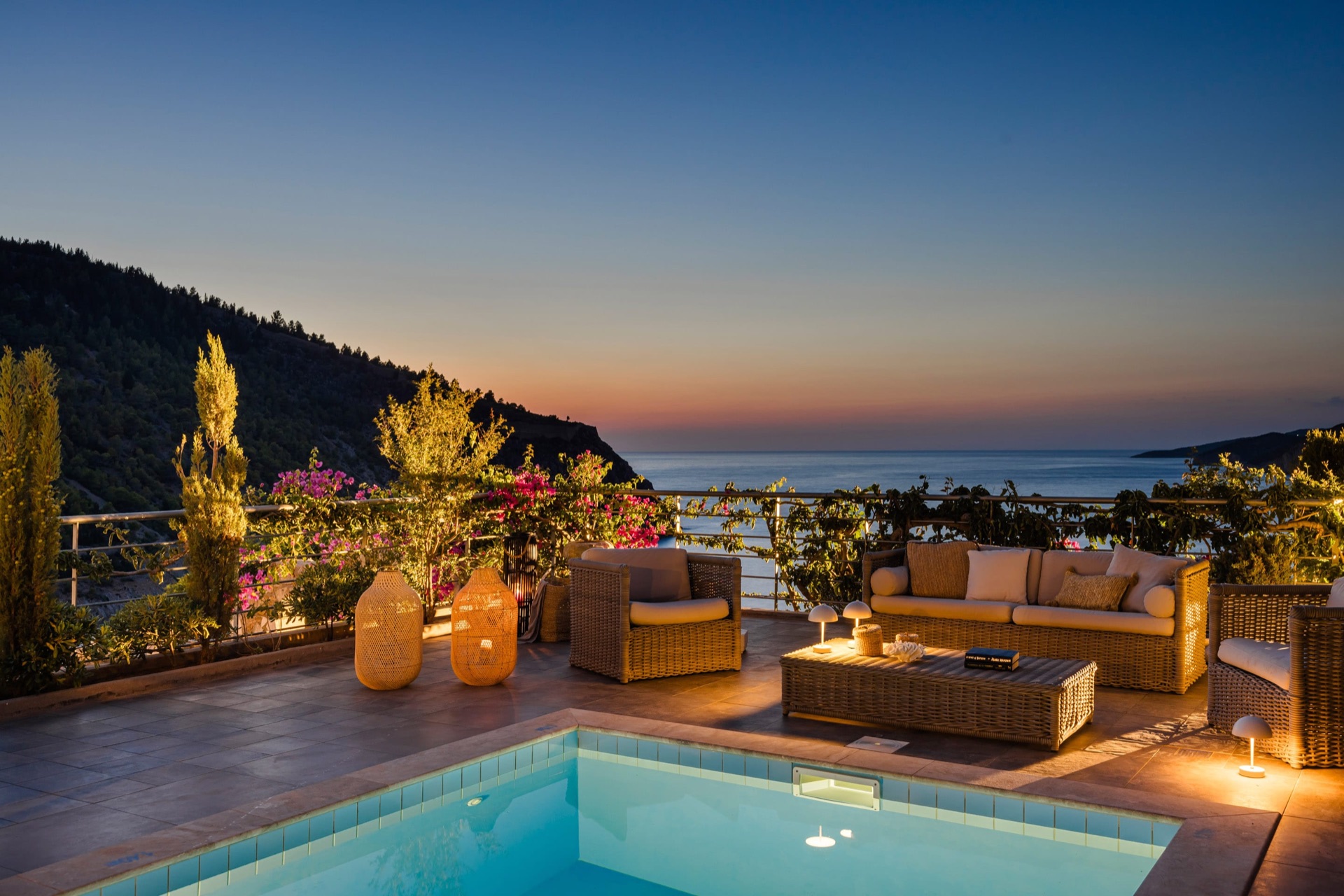 Evening pool terrace at Villa Glaroni with bougainvillea and sunset over the Ionian Sea
