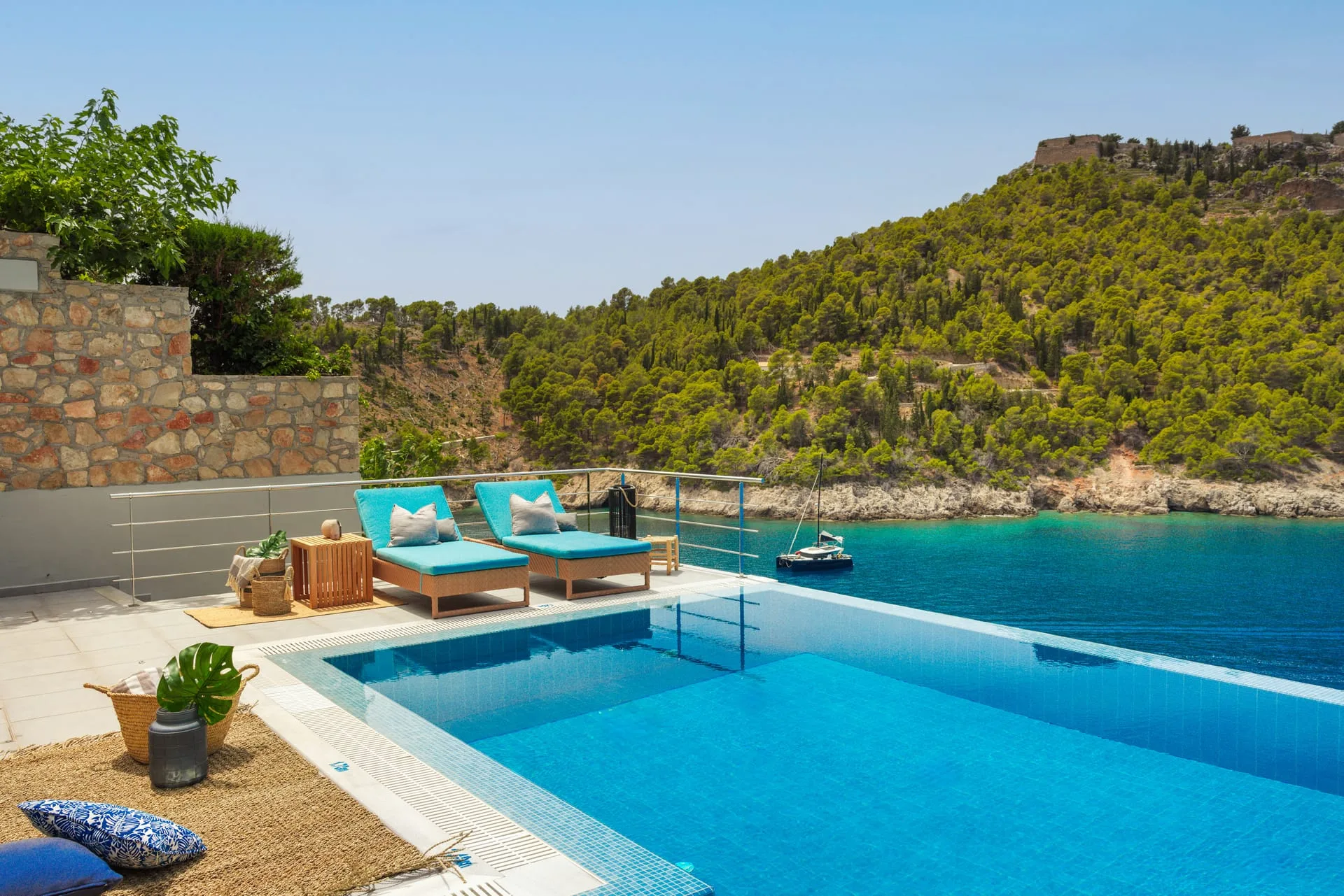 Private pool terrace at Braunis Horio looking across the bay to the fortress hill of Assos