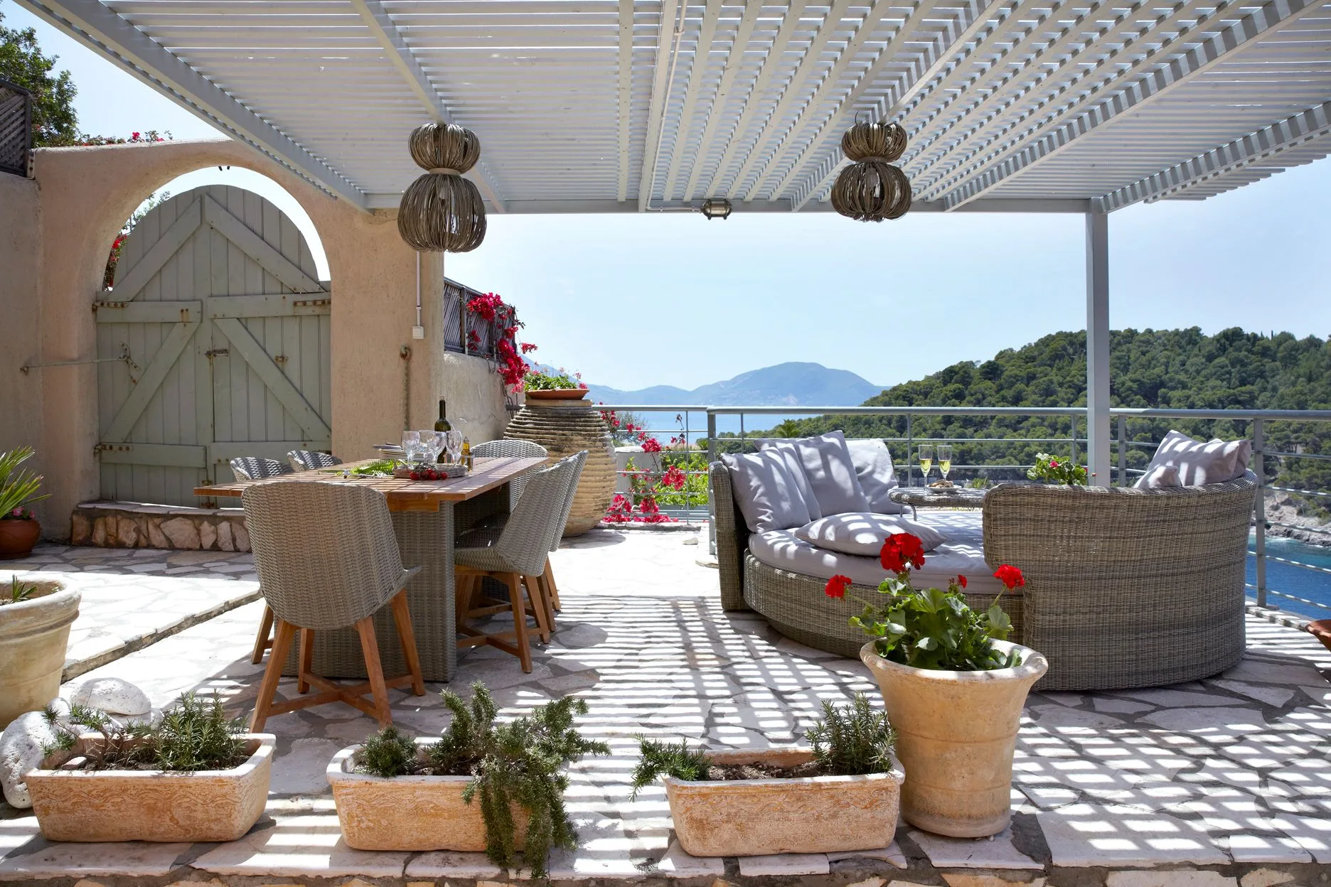 Poolside seating at Villa Nicolis overlooking the bay of Assos