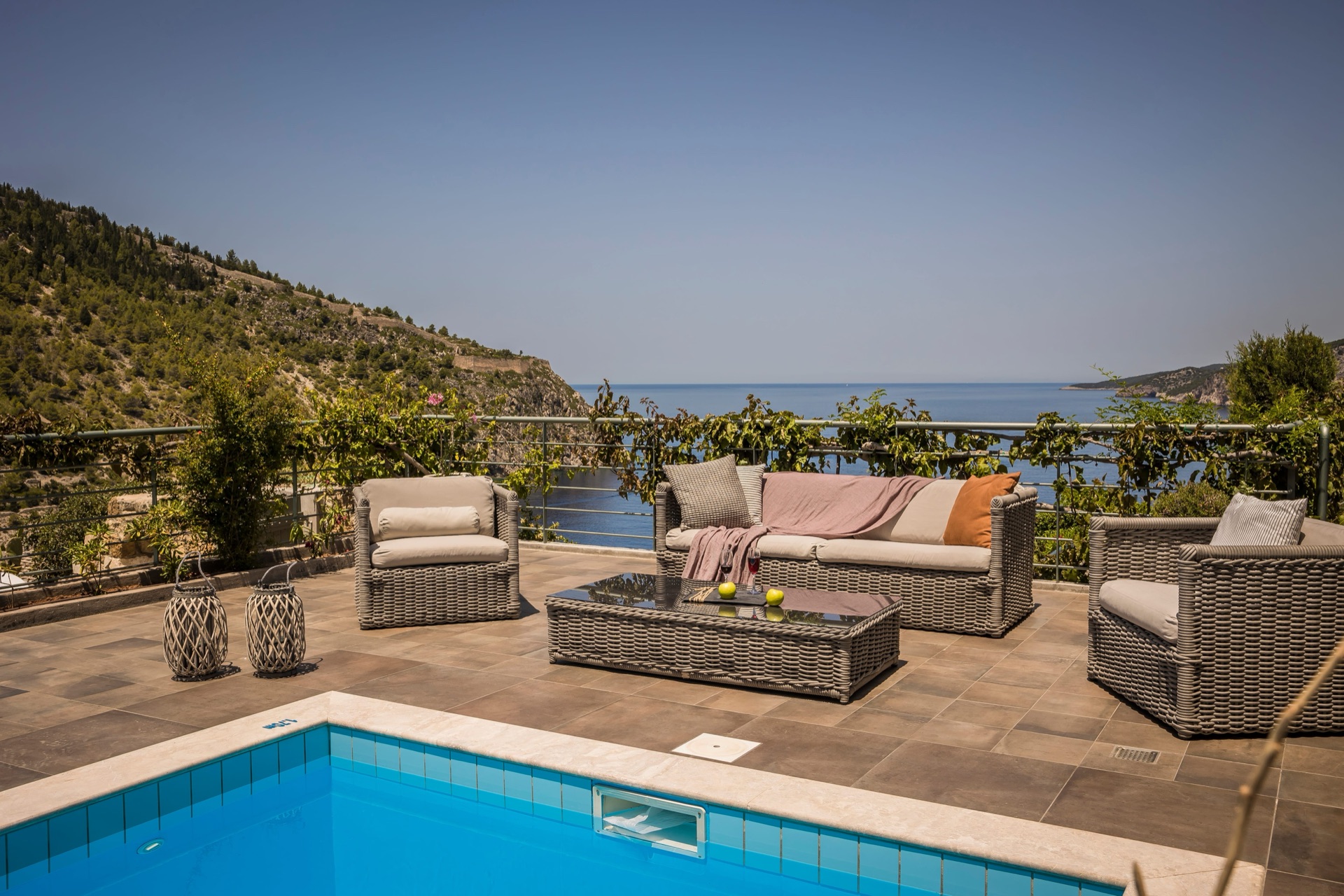 Terrace seating and a private pool above the water at Braunis Horio