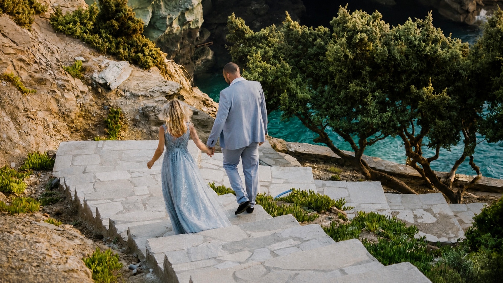 A couple descending towards the water at a Rock Bay Villas celebration