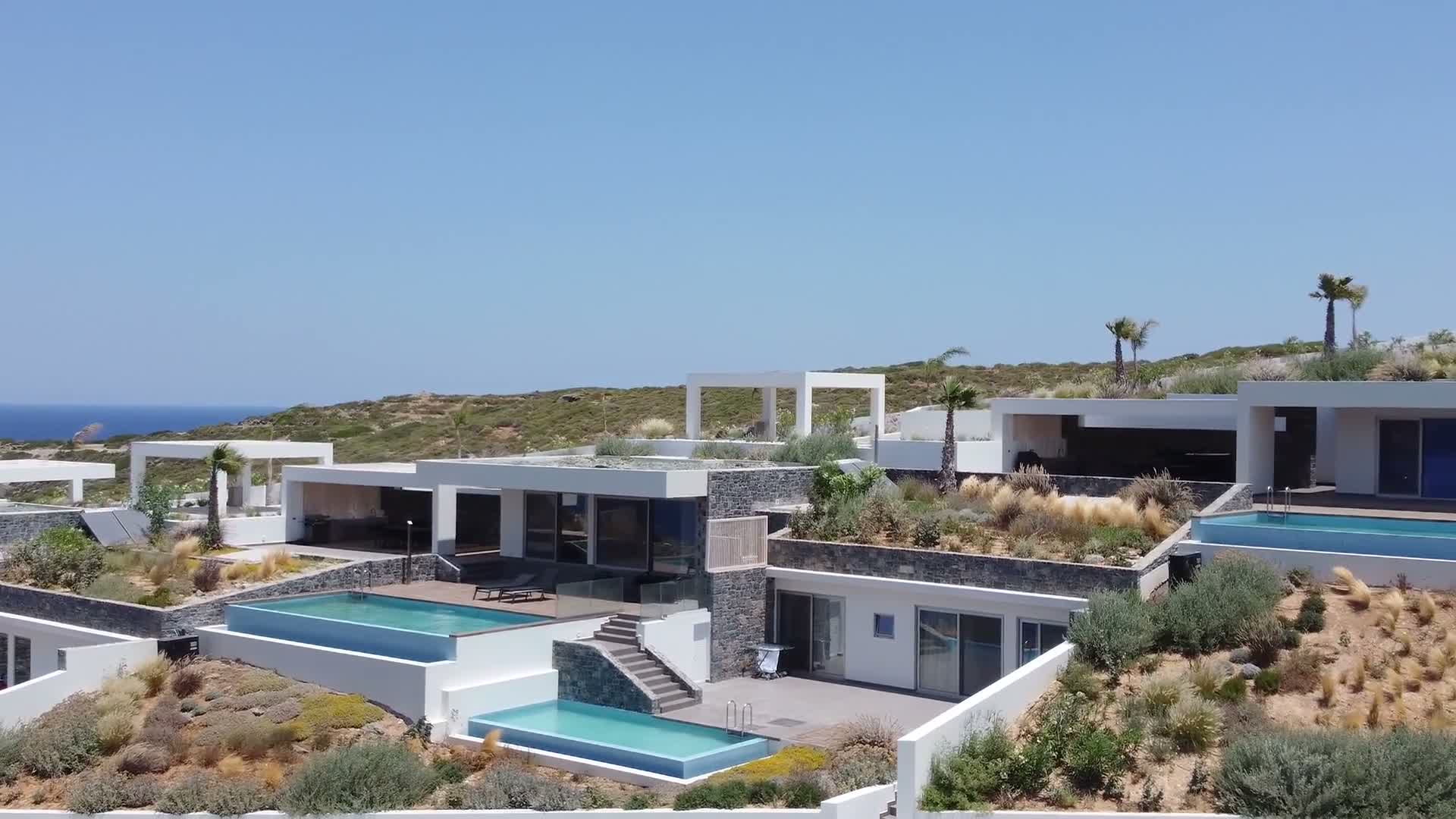Rock Bay Villas and their private pools overlooking the Cretan Sea