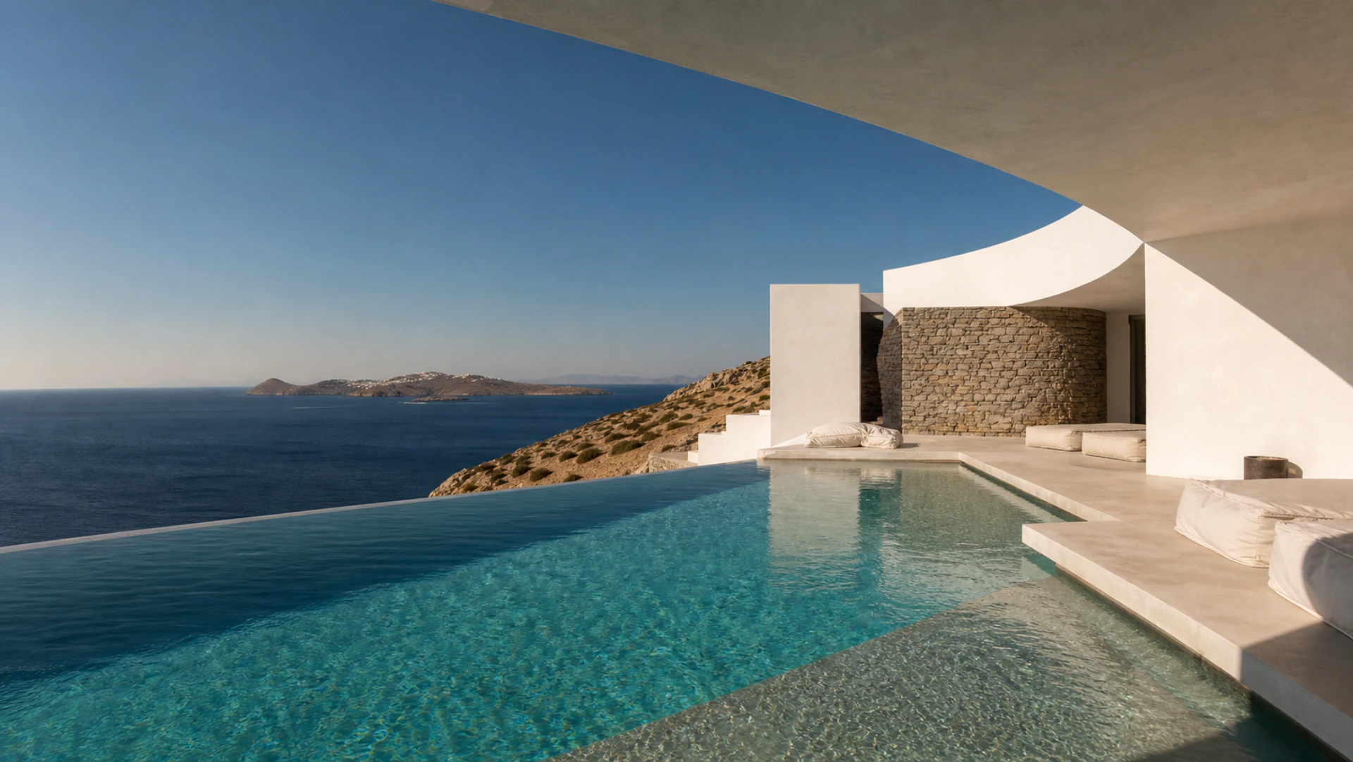 Editorial concept of a contemporary Greek island villa and infinity pool opening to the Aegean