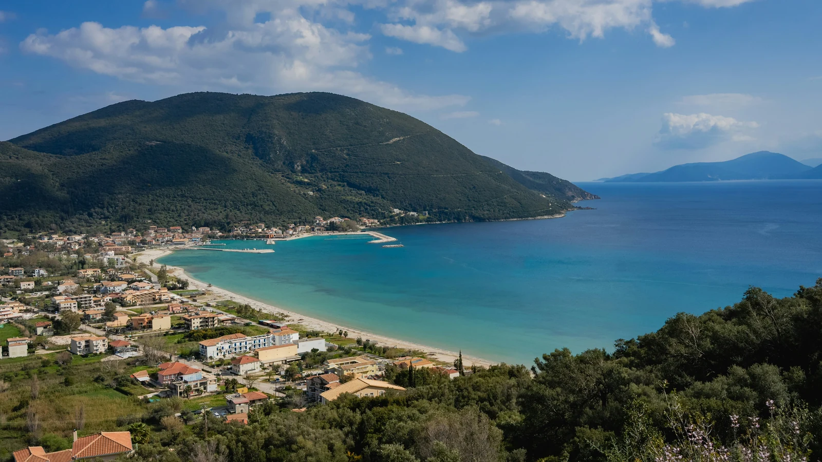 Vasiliki village and its wide bay seen from the green hillside above