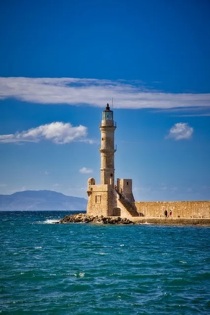 Venetian lighthouse at Chania harbour, Crete, against a blue sky