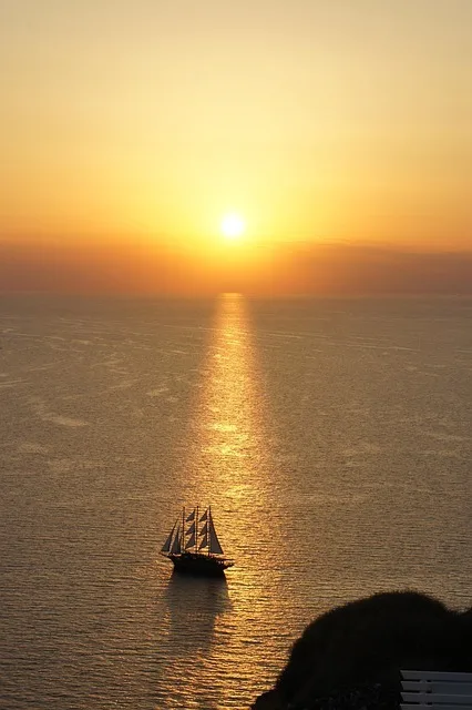 Golden summer sunset over the calm sea off Santorini