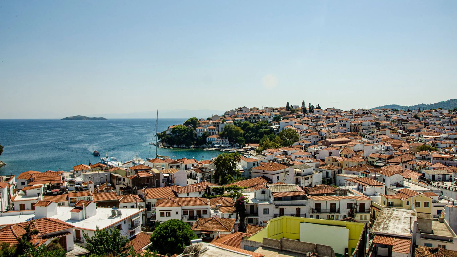 Skiathos Town and its harbour seen across terracotta rooftops